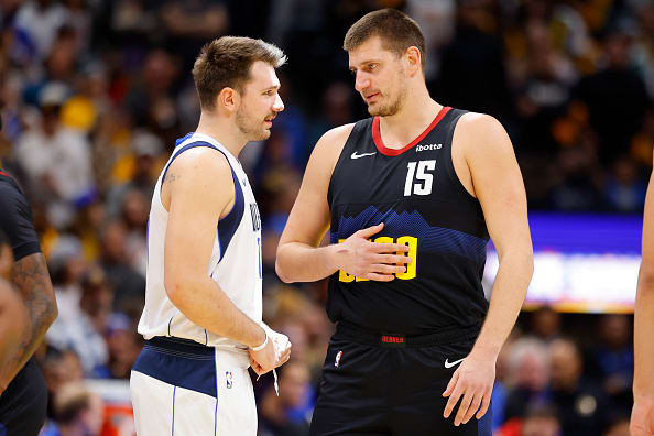 Luka Doncic talks to Nikola Jokic during the Dallas Mavericks’ game against the Denver Nuggets on Friday night.